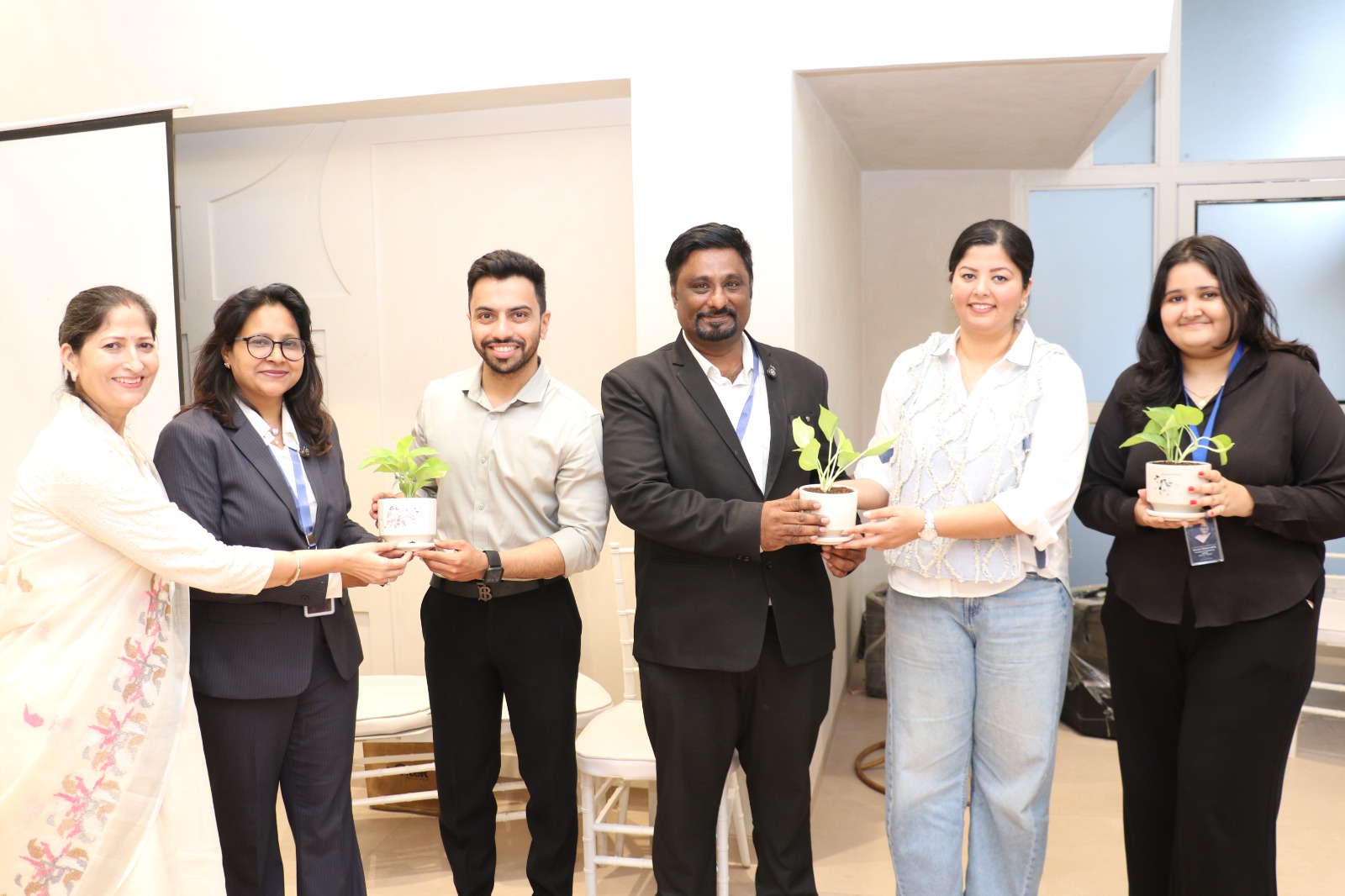 Achievement recognition moment with colleagues during corporate training programme