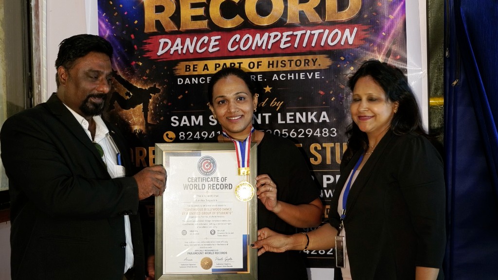 Adult dancer receiving world record certificate at Dreamers Dance Studio