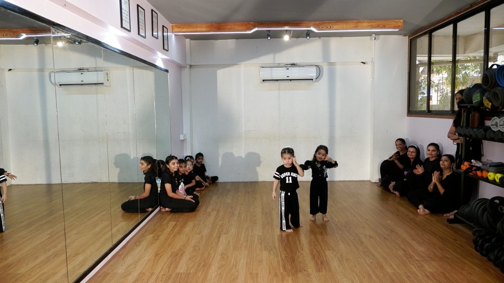 Students performing synchronized dance moves during world record rehearsal