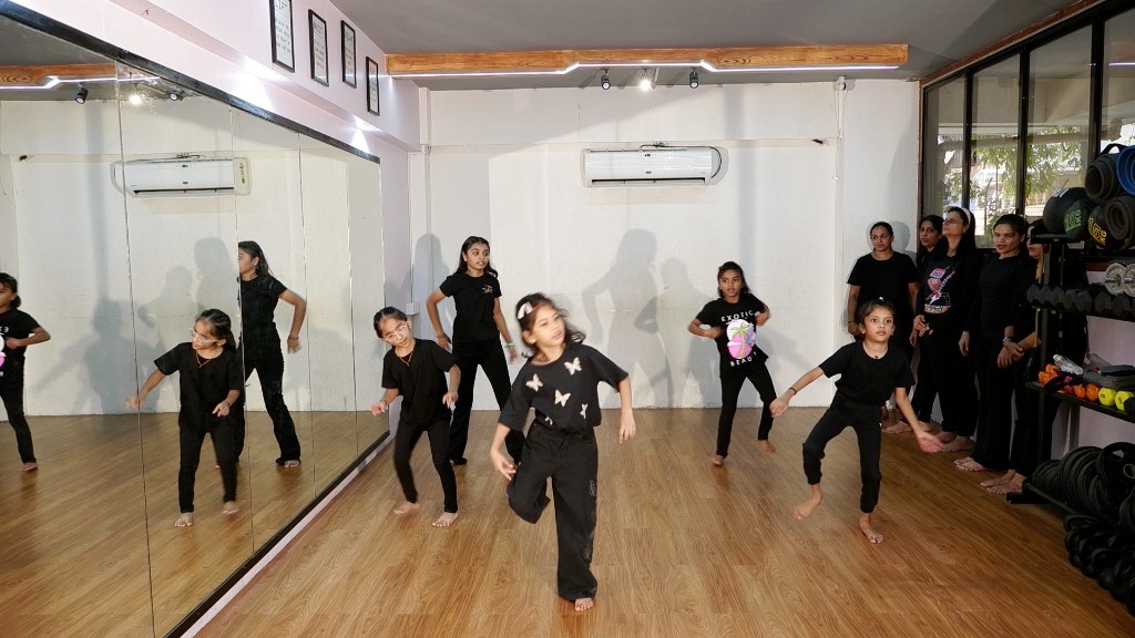 Award recipient with medal and certificate at Dreamers Dance Studio